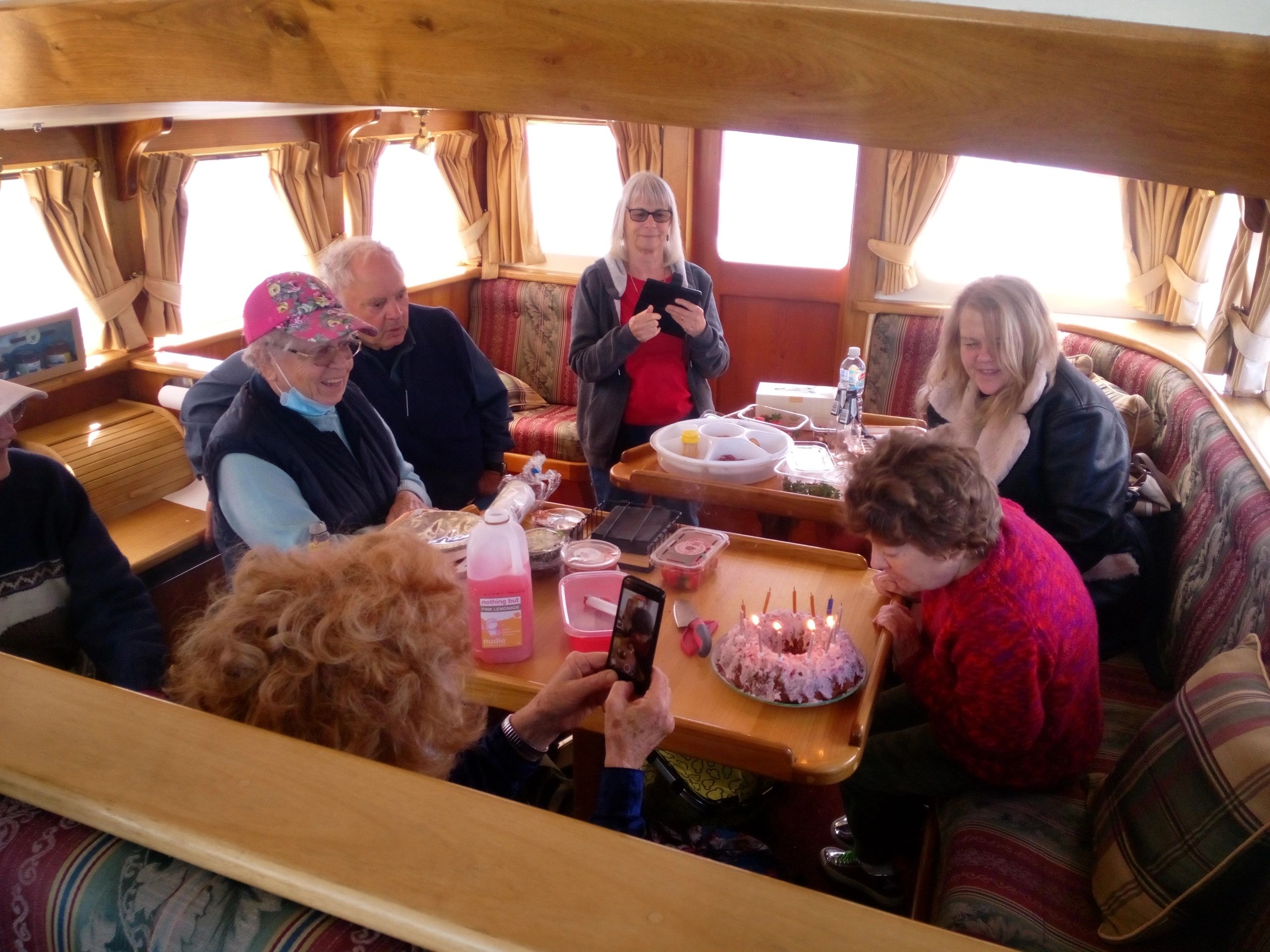 Birthday Cruise - Huon River Cruises - a group singing happy birthday in the comfortable cabin 