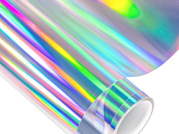 A roll of holographic rainbow-colored film reflecting light.