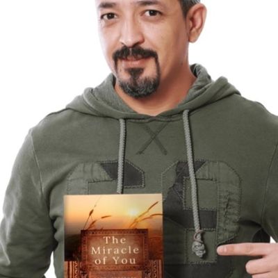 Man holding book the miracle of you