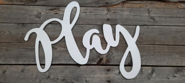White script word 'Relax' on rustic wooden background.