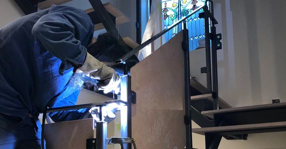 Toronto welder from Field Fabrication doing some finishing touches on 3 floors of stairs and railing
