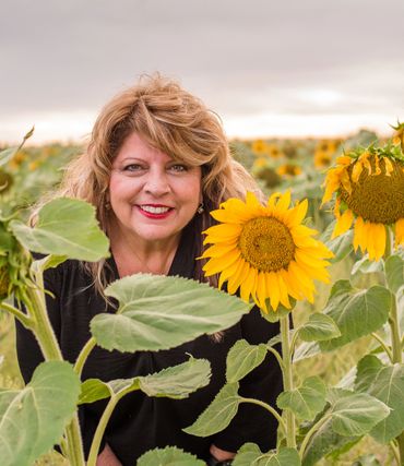 woman amidst some sunflowers