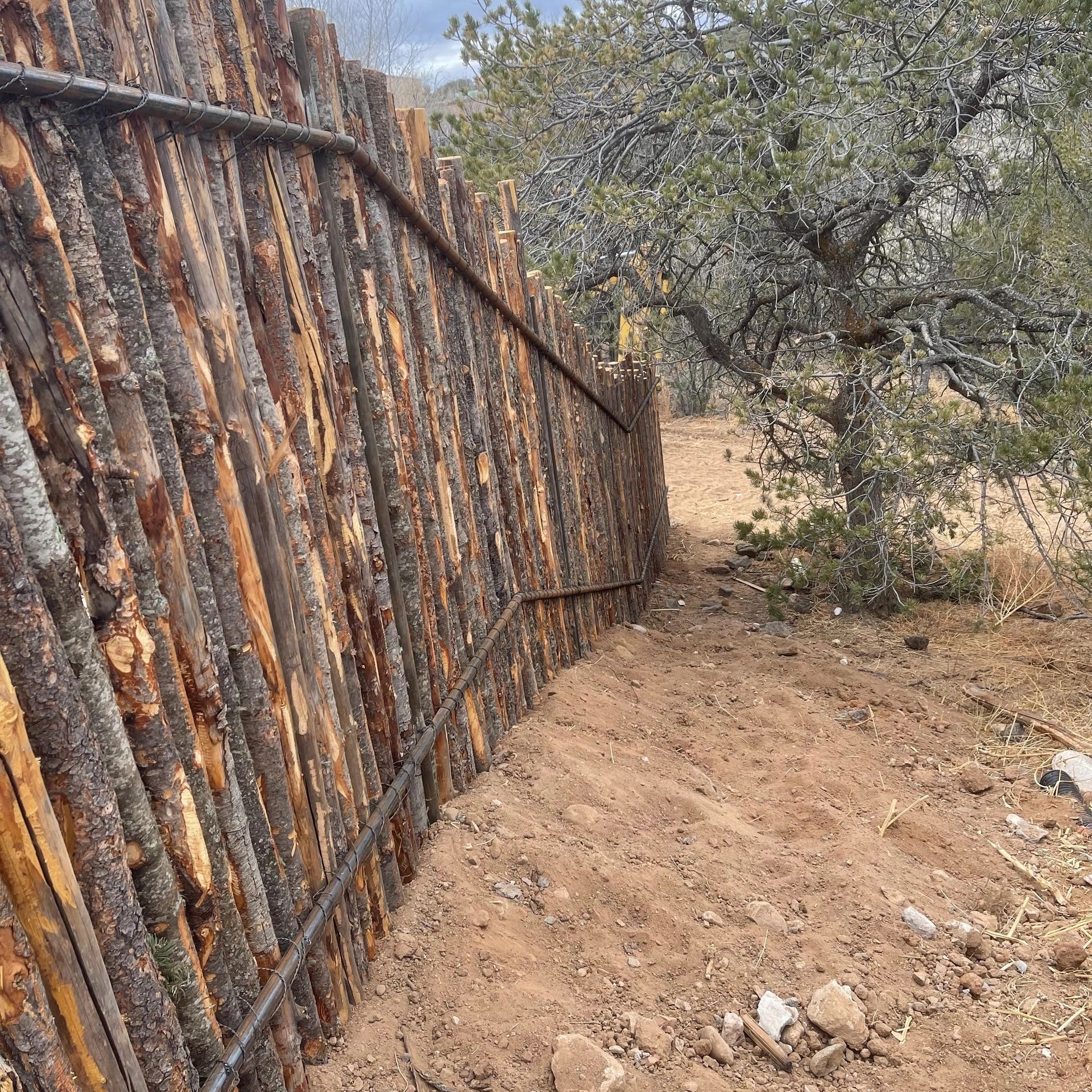 coyote fence installation in Albuquerque, New Mexico, durable wood for privacy and security.