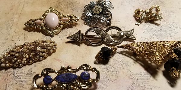 Antique brooches waiting to be made over