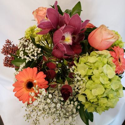 Flowers vase arrangement. Green hydrangeas, orange gerberas, orange roses & white baby's breath.Look us up under special moments flowers & gifts ltd