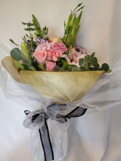 an elegant floral bouquet wrapped in golden paper and black ribbon.Oceana Florist deliver flowers in Vancouver. We are Vancouver house of flowers, Prince Rupert Florist & King Edward Florist.