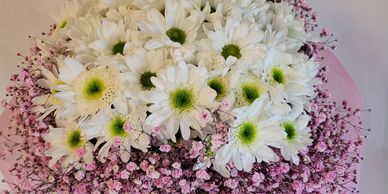 white mums and pink baby's breath floral arrangement