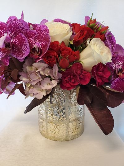 Elegant flower arrangement in a golden ceramic cylinder container.Order flowers from your Florist in Coquitlam - Oceana Florist is your special moments flowers & gifts ltd. Oceana Florist is your florist Coquitlam BC. We offer Coquitlam BC flower delivery & flower delivery Coquitlam BC. Look us up under flowers delivery Coquitlam.