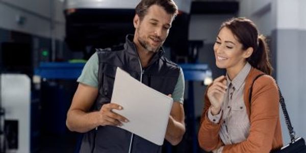 Two colleagues discussing work documents in a professional setting.
