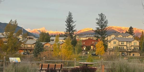 Sunlit mountains behind a peaceful suburban neighborhood.
