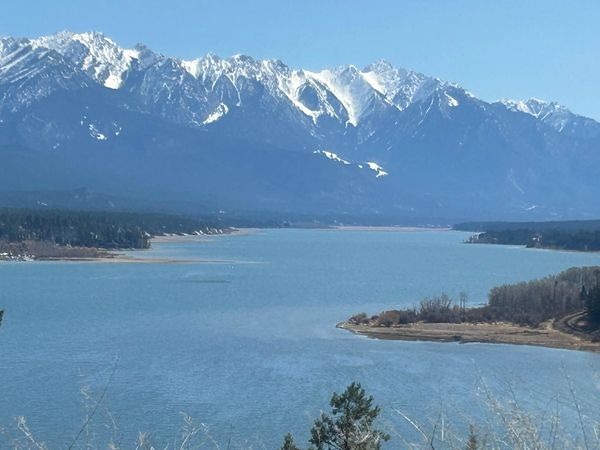 Snow-capped mountains overlooking a large lake.