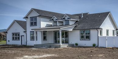 Custom Home with asphalt shingles and metal accent roof near Post Falls Idaho