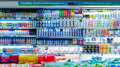 Dairy products displayed in a supermarket refrigerator.