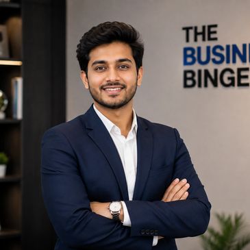 Confident young man in a suit with arms crossed.