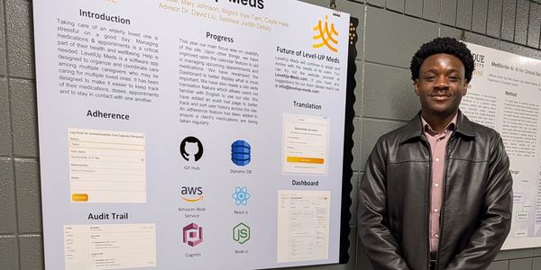 Person standing next to a project poster about medication adherence technology.