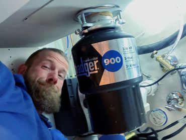 It's cozy underneath the sink installing a new garbage disposal and connecting up two dishwashers.