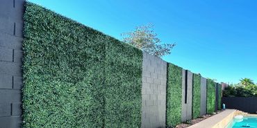 Let us transform your backyard with a little paint and some faux boxwood hedges.