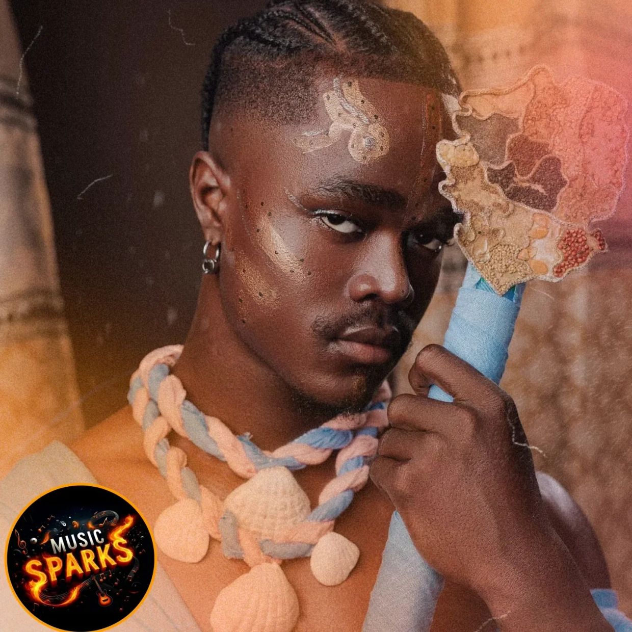 Portrait of a man with braided hair and artistic face paint.