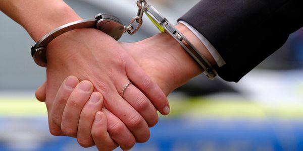 Married couple with police handcuffs