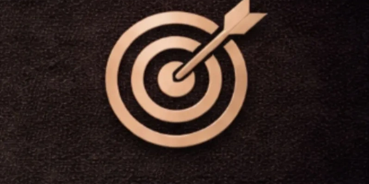 A dart hitting the bullseye on a target.