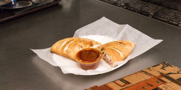 A picture of garlic bread sticks with sauce