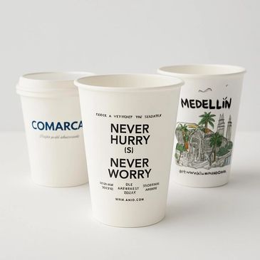 Three white coffee cups with different printed designs and texts.