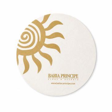 Round coaster with a golden sun design and Bahia Principe logo.