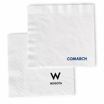 Two white branded napkins with 'COMARCH' and 'W BOGOTA' logos.