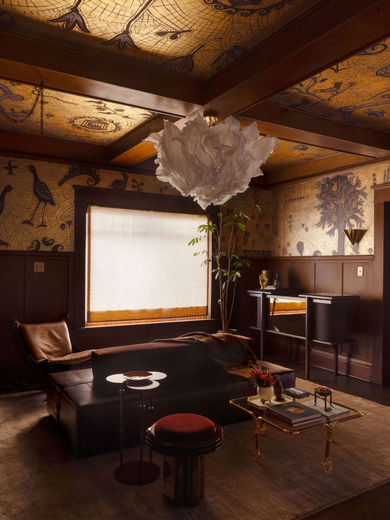 Cozy room with artistic wallpaper and unique chandelier.