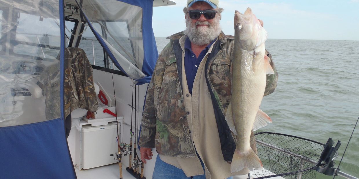 Owner and Captain of Lake Erie Fishing Charters, Don "Buffalo" Lowther proudly displaying his catch 