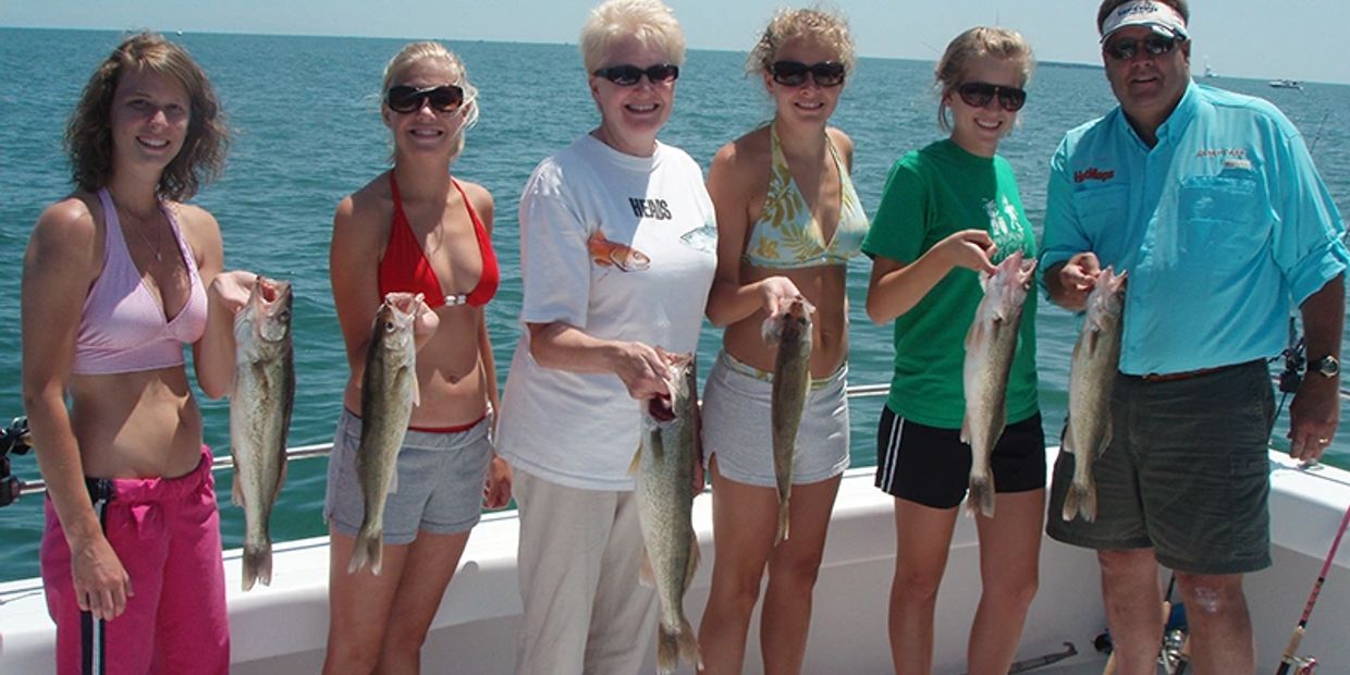A happy group of family members displaying their fish on board the Osprey Island Hopper.