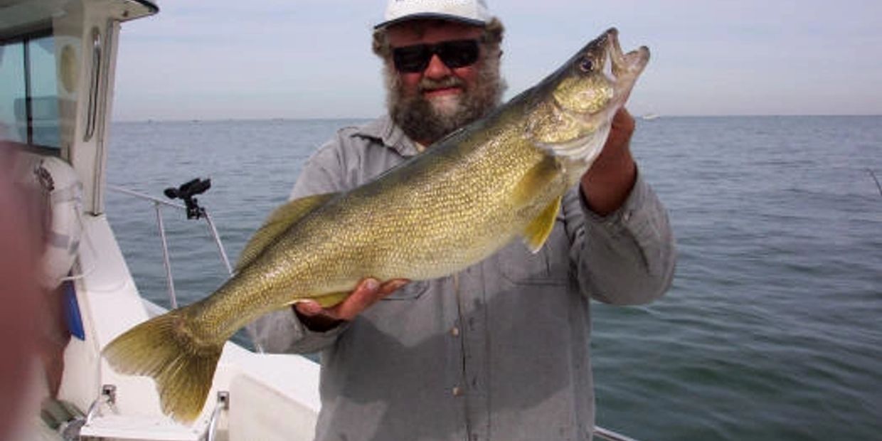 Captain Don Lowther, of Lake Erie Fishing Charters, holding a large catch. 