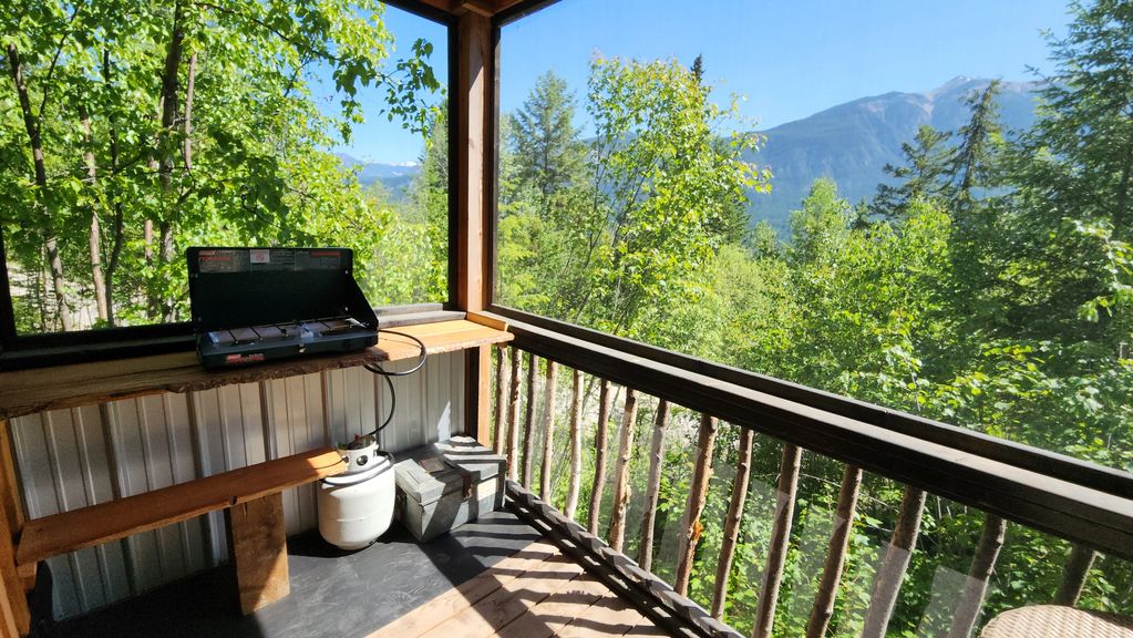covered, screened cooking area with double camp stove