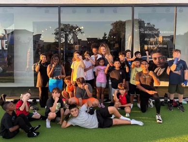 kids group photo outside for boxing class. lots of smiling kids faces