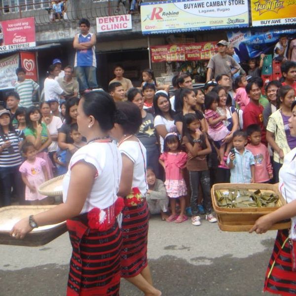 Colorful parade during the Hungduan festival, with locals carrying rice baskets.