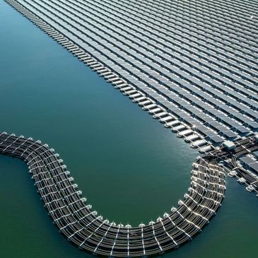 A large floating solar system on water with a curved walking platform.