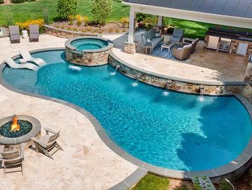 Backyard pool with spa and seating area.