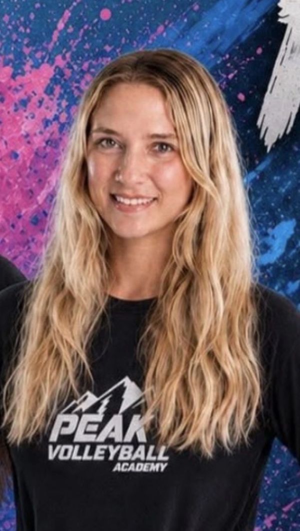 Young woman with blonde hair wearing a Peak Volleyball Academy shirt.