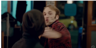 Michael throwing a punch at another actor