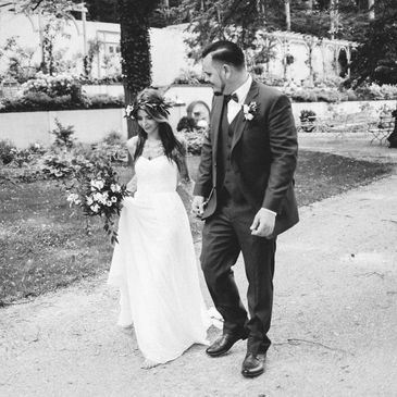 Black and White photography of couple at wedding holding hands in boho style.