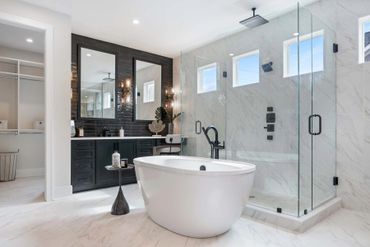 Modern bathroom with a freestanding tub and glass shower.