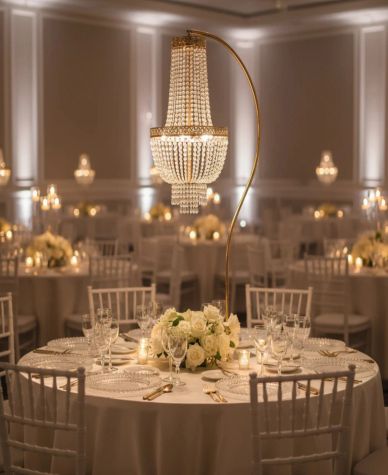 Elegant chandelier above a floral centerpiece at a wedding reception.