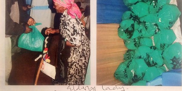 Orphaned and disabled children file image of food distribution at community center in Banana Hills