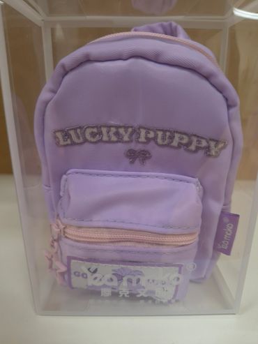 Mini purple backpack with 'LUCKY PUPPY' text in a clear box.
