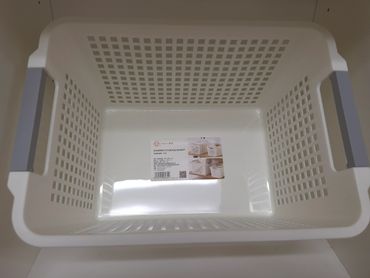 White plastic storage basket with gray handles and ventilation holes.