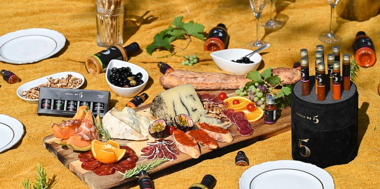 charcuterie board on a picnic blanket