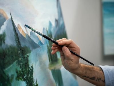 side view man holding painting brush