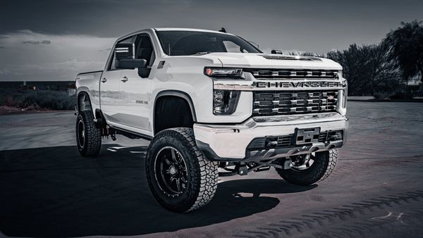 Chevrolet lifted white truck, with new wheels and tires