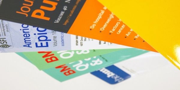 Stack of academic journals in various colors.