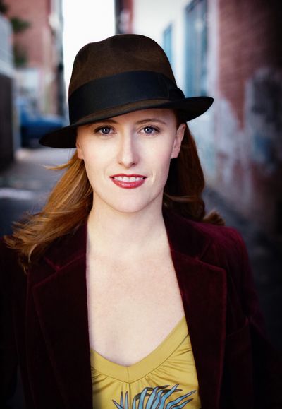 Julie O'Hara wearing a hat in an alley